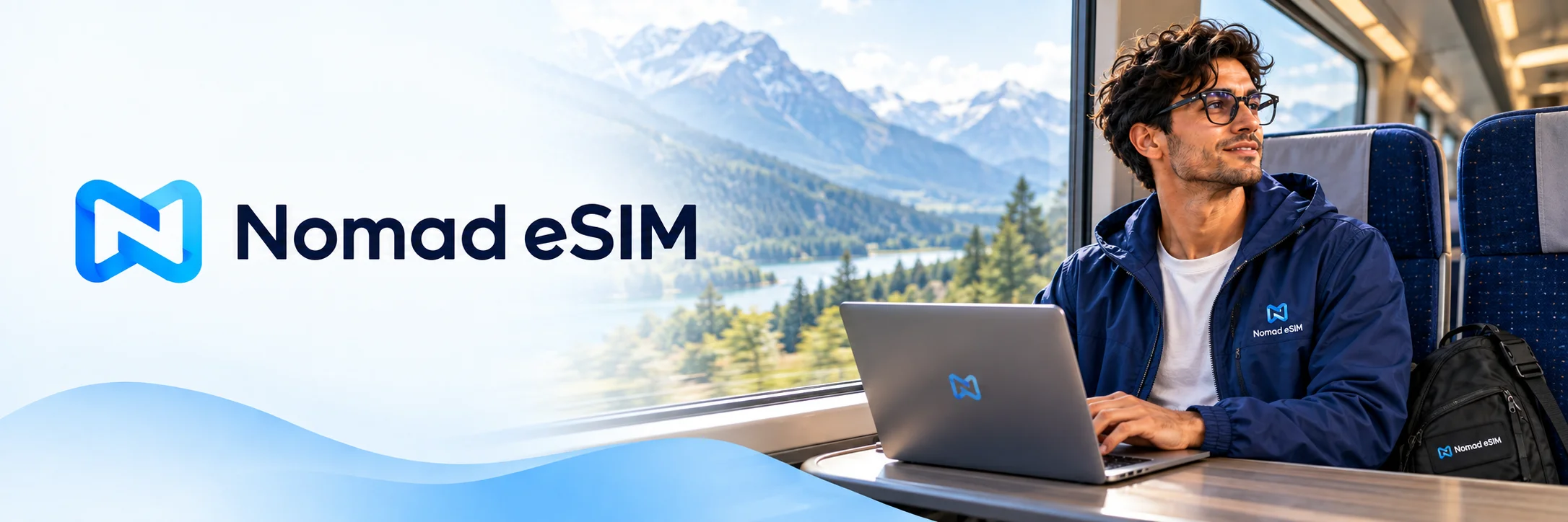Nomad eSIM logo beside a traveler with a laptop on a train overlooking the mountains